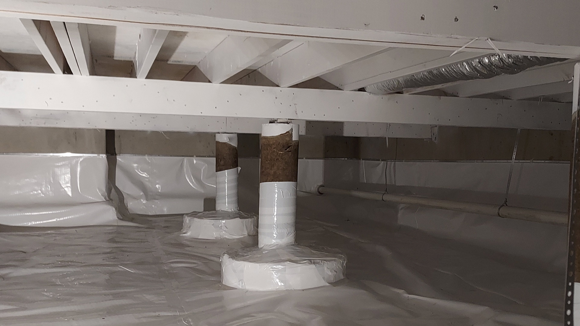 crawlspace-with-white-beams-and-moisture-barrier-nixa-mo